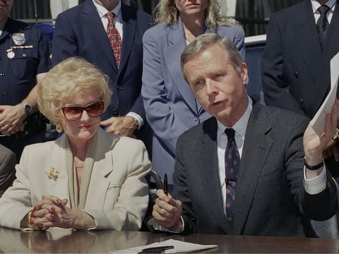 Sen. Marian Bergeson sits with California Gov. Pete Wilson in 1994 as he signs a "one-strike" bill she authored. Bergeson was the first woman to serve in both the State Assembly and Senate.